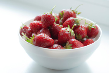 Fresh strawberries in a white bowl