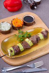Roasted on a skewer meat with zucchini