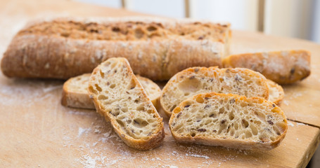fresh loaf of bread on wooden board