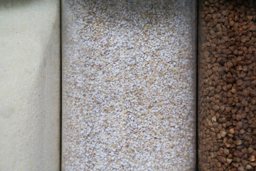 cereals on a linen gray tablecloth, buckwheat, semolina, wheat