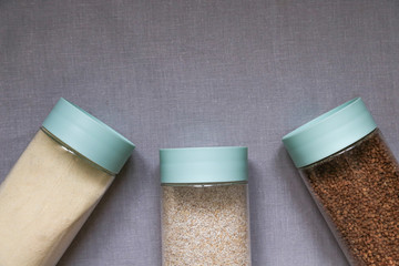 cereals on a linen gray tablecloth, buckwheat, semolina, wheat