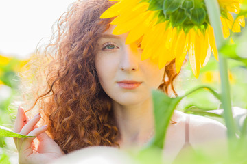 The red hair girl in sunflowers field