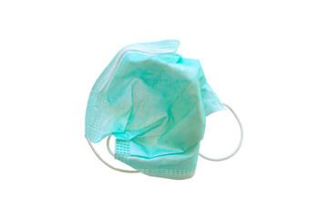 Used green medical surgical mask, Medical protective mask on white background. Disposable surgical face mask cover the mouth and nose. Selective focus.