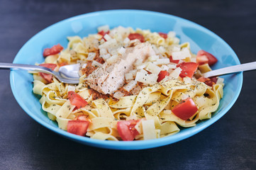 first person view of pasta dish with natural tomato, tuna and a touch of cheese. Ready-to-eat concept