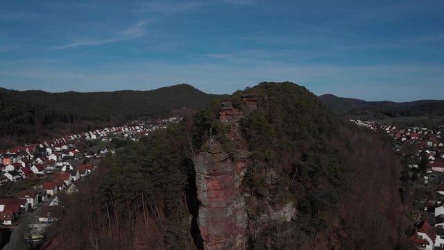 Aerial shot of a precipitous rock formation called Jungfernsprung in the small german town of Dahn. 
