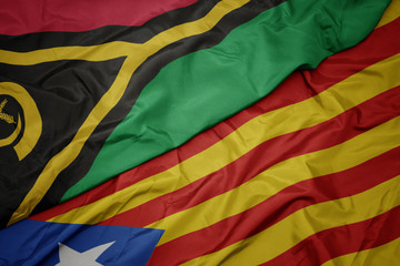waving colorful flag of catalonia and national flag of Vanuatu .