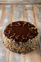 Chocolate and cherry torte with almond flakes and golden chocolate decoration