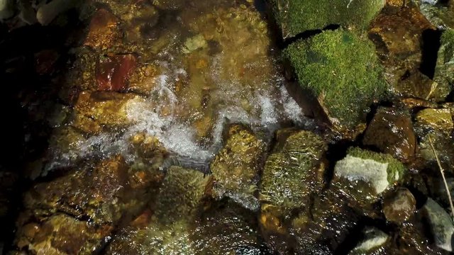 Fast Aerial view as close-up over a torrent with small waterfalls in the Black Forest in a beautiful landscape in the spring