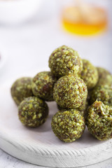 No bake matcha energy bites or balls, prepared with natural ingredients, such as nuts, matcha powder, dates