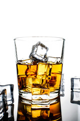 Whiskey with ice cubes.Isolated shot of whiskey.Glass of scotch and ice cubes on a white background.