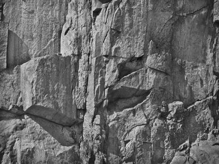 White grunge background with rock texture. Gray stone background. The surface of the mountain. Monochrome. Close-up. Fantastic rock image.