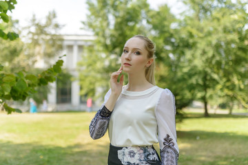 Outdoors portrait of beautiful young woman in the park. Selective focus.