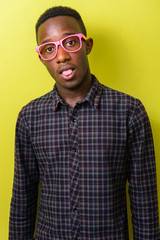 Portrait of young African hipster man sticking tongue out