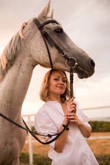 Obraz premium Portrait of a girl in a white shirt with a horse