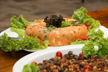 natural couscous salad of corn flour, eggs, olives, decorated with cherry tomatoes, parsley, green...