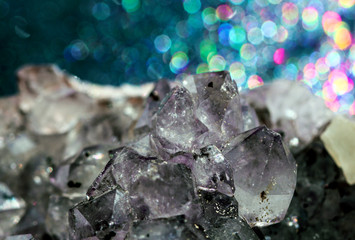 Bokeh rainbow light reflections on healing Amethyst Quartz wild jewels.