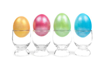 colorful eggs in glass on white