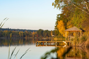 A small gazebo and a pier near the lake for fishing.