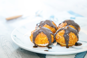 Profiterole with vanilla and chocolate sauce