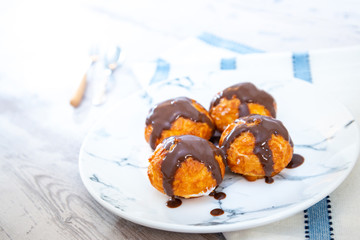 Profiterole with vanilla and chocolate sauce