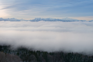 Morning sky and cloud over the snow capped alps mountain range.
