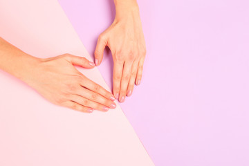 female  manicure. Beautiful young woman's hands in heart shape on pastel pink  background- Image