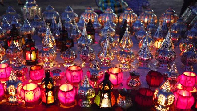 night shot of small metal lanterns with burning candles at a market in marrakech, morroco