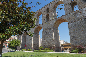 Fototapeta na wymiar Medieval aqueduct Kamares in the Kavala city. Sunny summer day in the Macedonia, Greece, Europe.