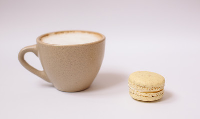 Homemade colorful macaron on the white background.Cup of coffee.