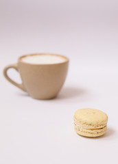 Homemade colorful macaron on the white background.Cup of coffee.