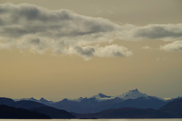 Picturesque mountain range landscape scenery with pastel colors sky and clouds while cruising...