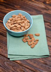 Bowl with almonds nuts. Healthy snack, organic vegetarian food