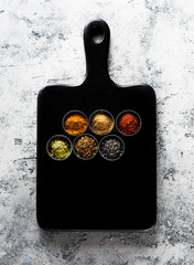 spices seasoning spicy on a wooden board, top view. Indian spices cooking on gray concrete background