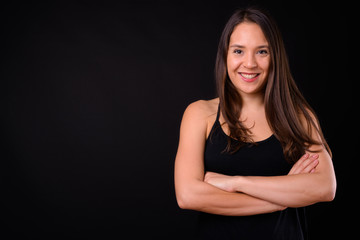 Young multi ethnic beautiful woman against black background