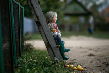 child walks in the village and harvests