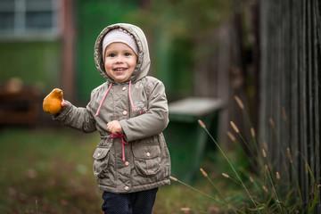 child runs through the village