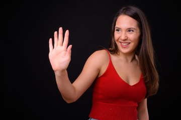 Young multi ethnic beautiful woman against black background
