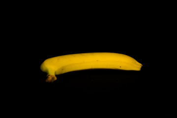 Yellow ripe banana on a black background