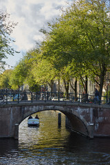 Fototapeta na wymiar A bridge over an Amsterdam canal with bikes parked