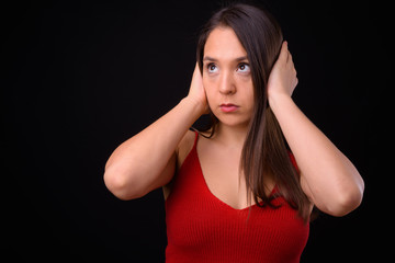 Obraz premium Young multi ethnic beautiful woman against black background