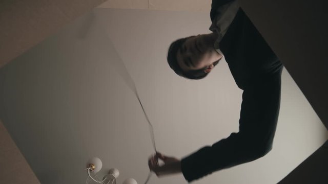 A young man fills the cardboard box with different parts of his computer