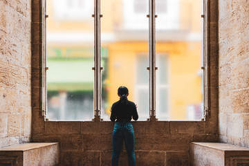 women looking outside through a window