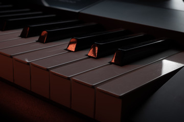 Piano and synthesizer on a dark button background