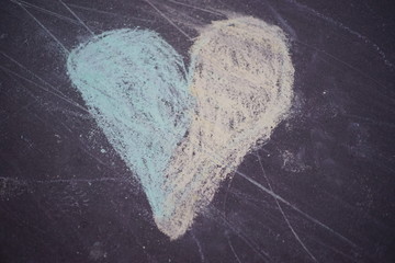 Colorful heart chalk drawing - drawn by a child on a pedestrian pavement, asphalt
