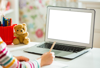 Primary school student having video conference call with teacher using webcam. Online education and...