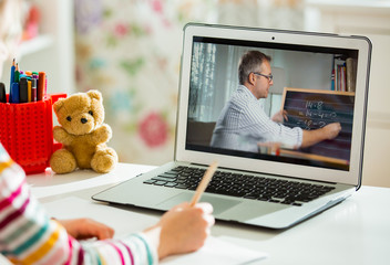Middle-aged distance teacher having video conference call with pupil using webcam. Online education...