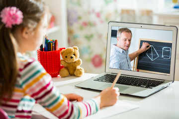 Middle-aged distance teacher having video conference call with pupil using webcam. Online education...