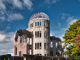 Against a blue sky with light clouds, the Atomic Bomb Dome at the Hiroshima Peace Memorial Park in Hiroshima, Japan - originally the Hiroshima Prefectural Industrial Promotional Hall
