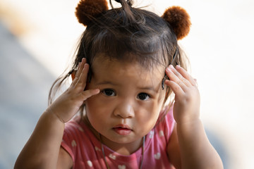 Closeup portrait of a cute little thai girl thinking, Close up portrait of a cute little girl