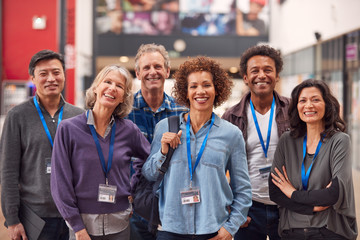 Portrait Of Group Of Smiling Mature Students Standing In College Hall